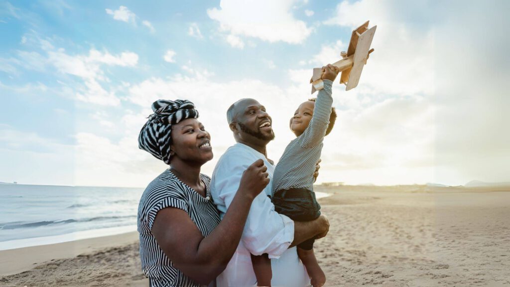 Family on beach holding child